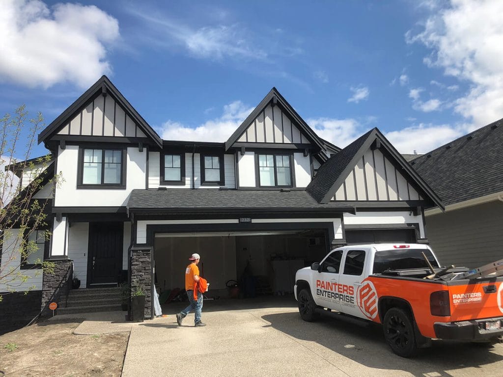Painters Enterprise van outside a freshly painted Edmonton home